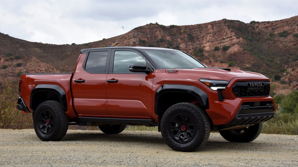 2025 Toyota Tacoma TRD Pro parked on dirt with red hills in the background.