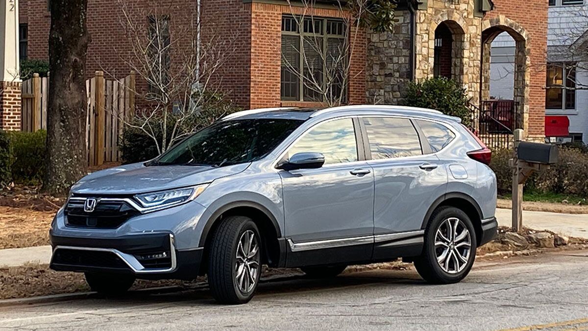 2021 Honda CR-V Touring hybrid parked outside on the street.