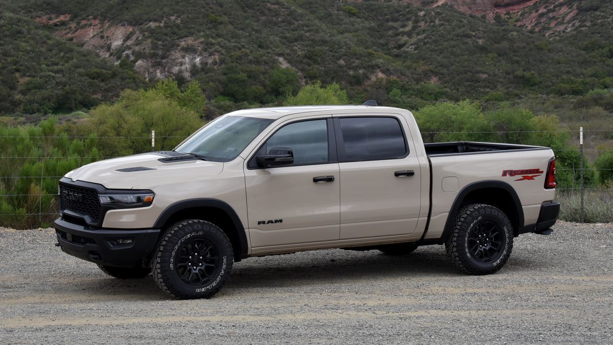 2025 Ram 1500 Rebel X parked on a dirt road with red hills in the background.