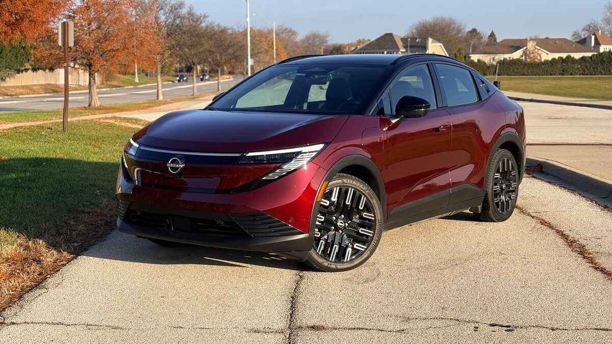 Nissan Leaf parked by trees.