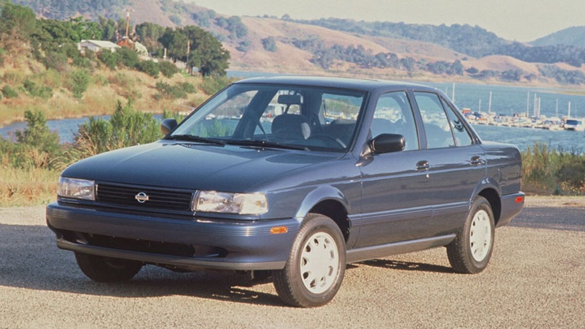 1994 Nissan Sentra parked by a body of water.