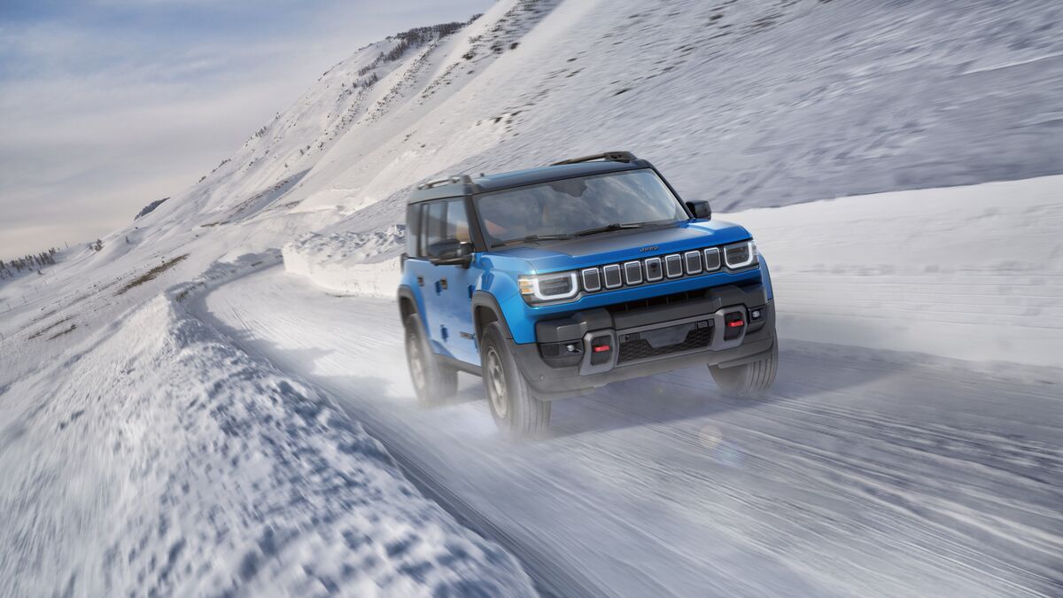 The 2026 Jeep Recon in blue seen from a front quarter angle in snow