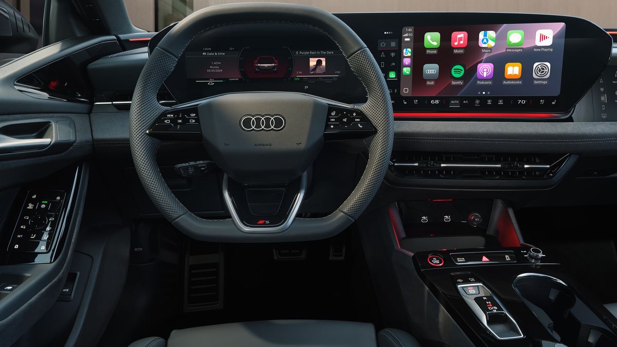 2025 Audi S6 Sportback e-tron driving on a road near the ocean.