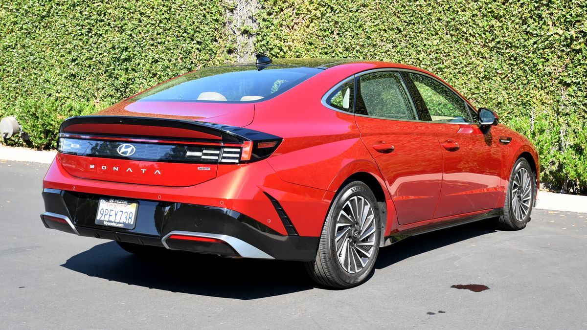 2025 Hyundai Sonata Hybrid parked near greenery.