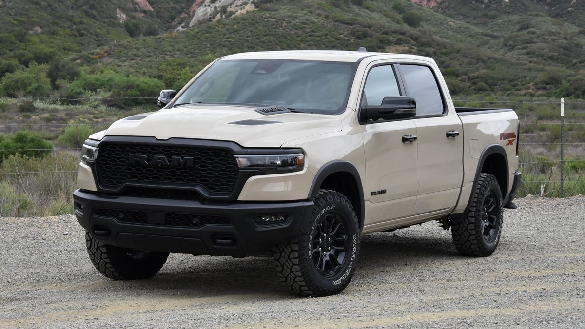 2025 Ram 1500 Rebel X parked on a dirt road with red hills in the background.