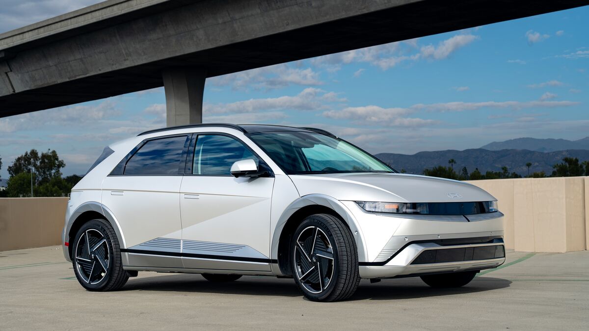 A front 3/4 view of the Hyundai Ioniq 5 parked on a cement parking structure on a sunny day.