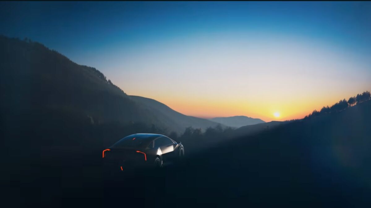 A still image from a video teasing a mysterious new Kia concept car, seen from a rear quarter angle