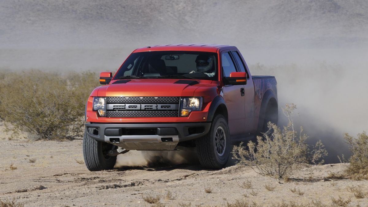 2010 Ford F-150 Raptor SVT driving through the desert.