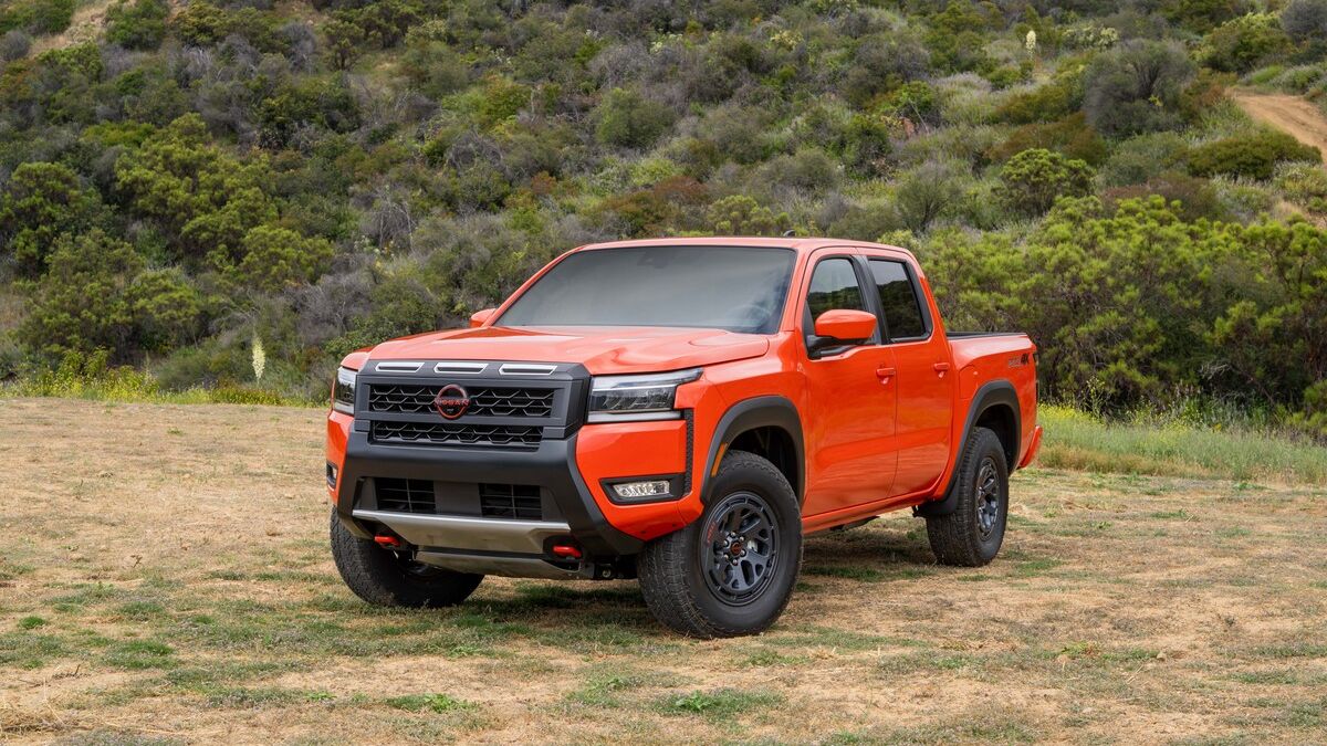 2026 Nissan Frontier parked by a bunch of trees.