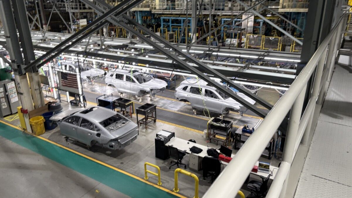 Honda CR-Vs on a production line in an Indiana factory, seen from a catwalk overhead