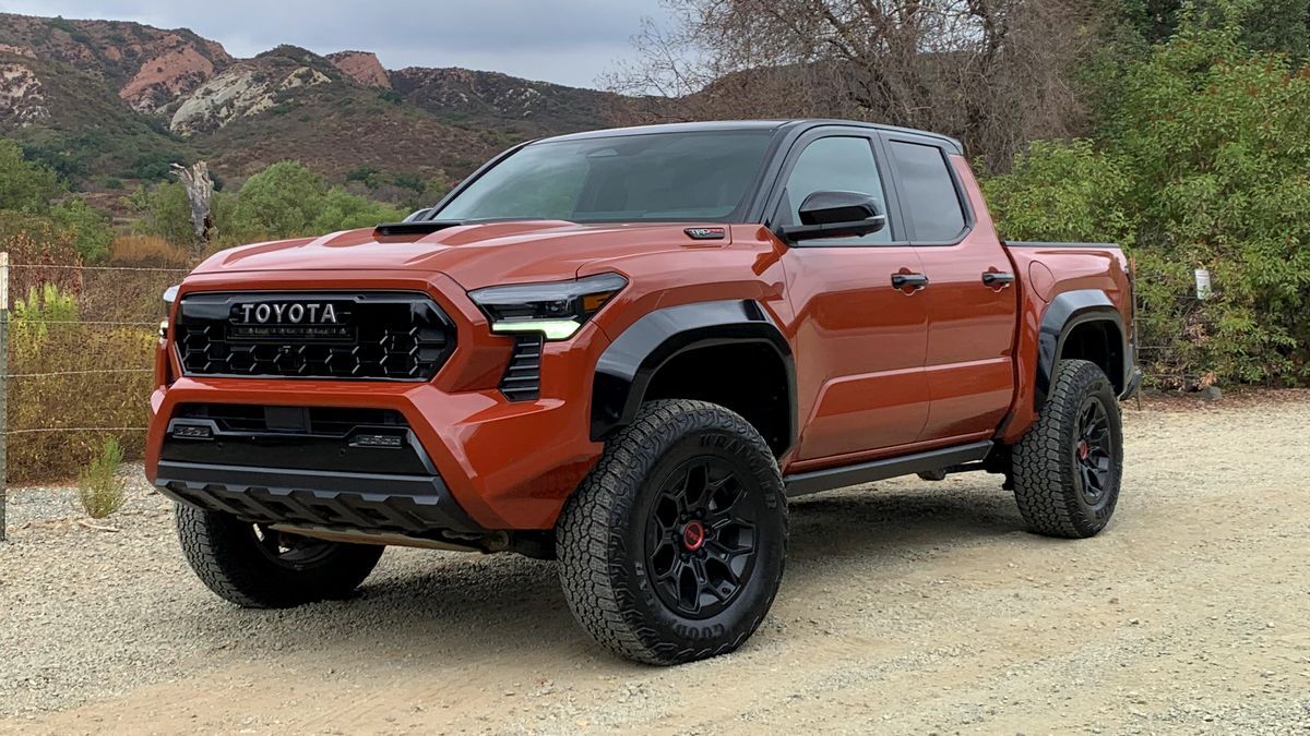 2025 Toyota Tacoma TRD Pro parked on dirt with red hills in the background.