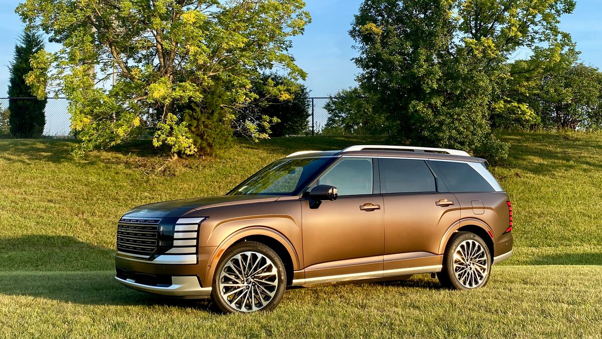 2026 Hyundai Palisade parked on grass with trees around.