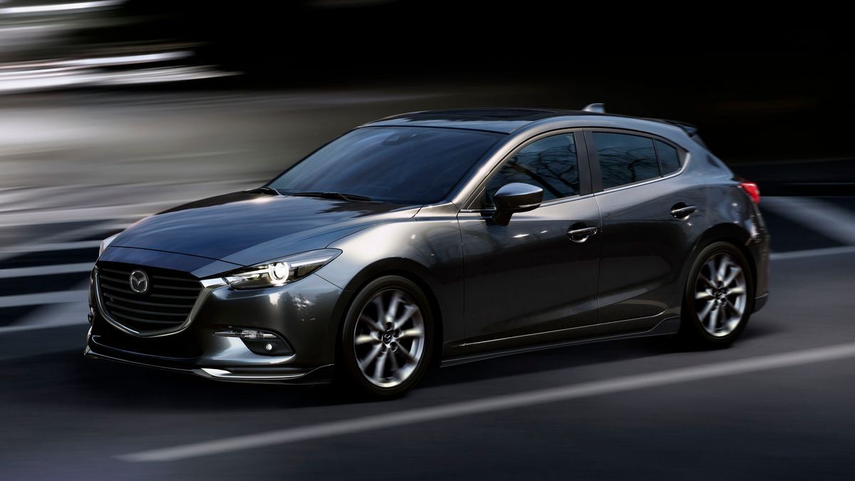 2017 Mazda3 driving on a dark city street.