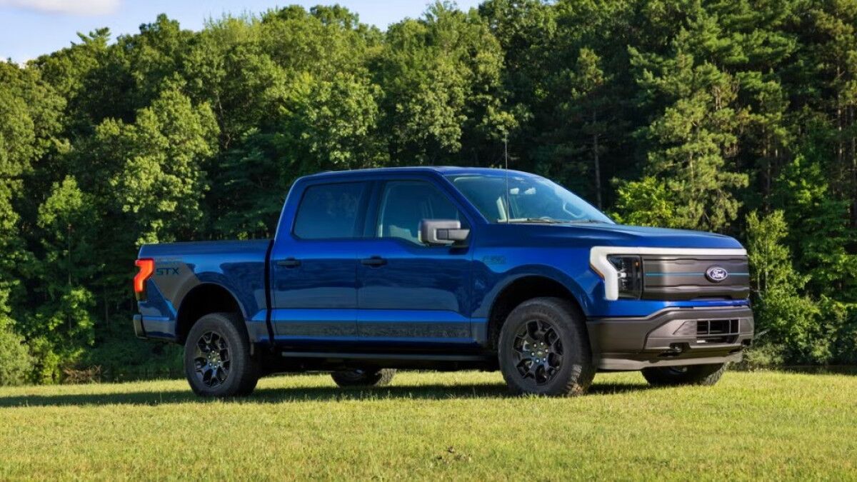 The 2025 Ford F-150 Lightning in blue seen from a front quarter ange