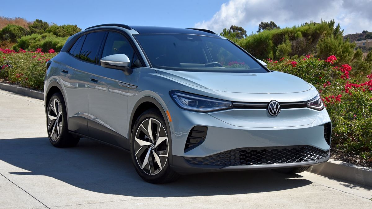 2025 Volkswagen ID.4 parked on a street near green plants.