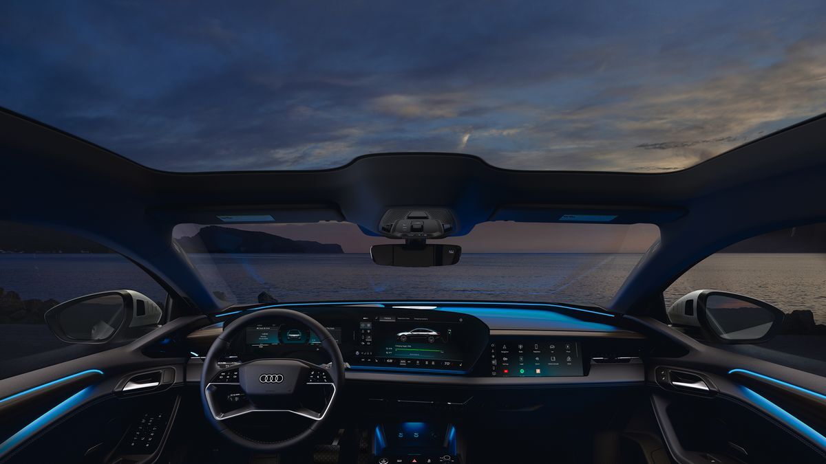 2025 Audi A6 Sportback e-tron parked in front of a contemporary home.