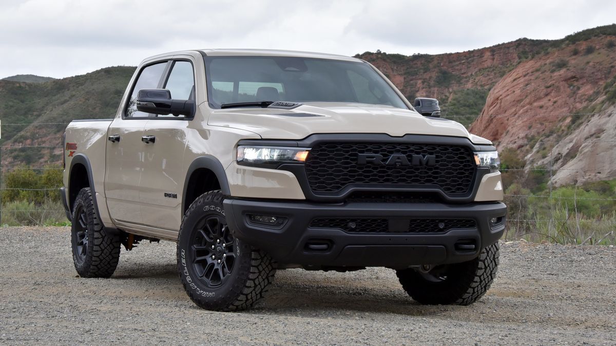 2025 Ram 1500 Rebel X parked on a dirt road with red hills in the background.