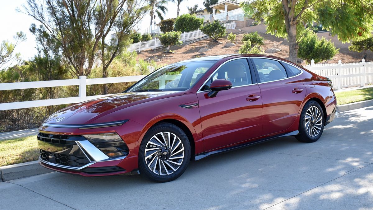 2025 Hyundai Sonata Hybrid parked near greenery.