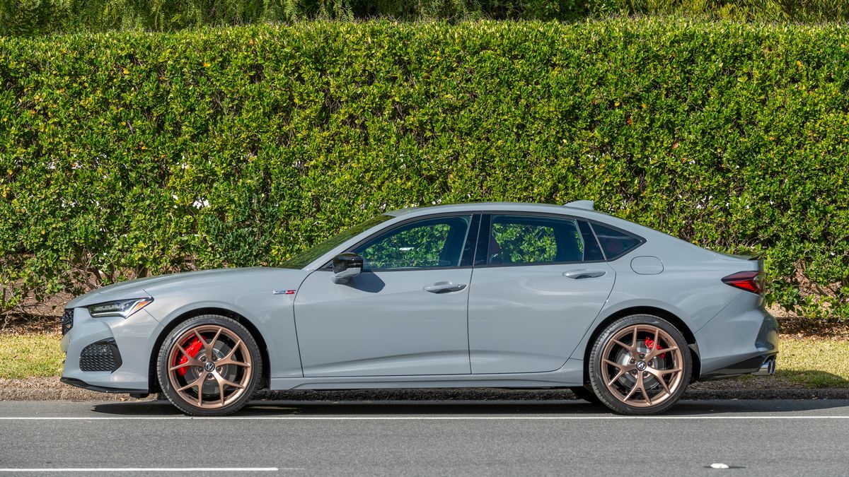 2025 Acura TLX Type S parked next  to a tall green hedge.