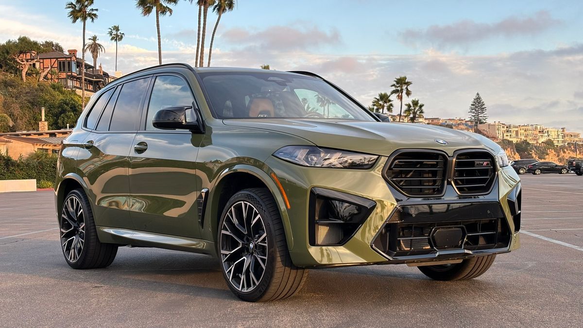2024 BMW X5 M Competition in a parking lot at sunset.
