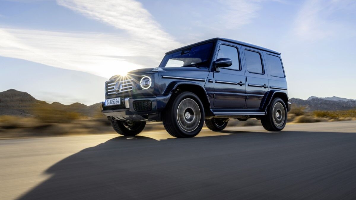 The 2025 Mercedes-Benz G-Class in blue seen from a low front quarter angle