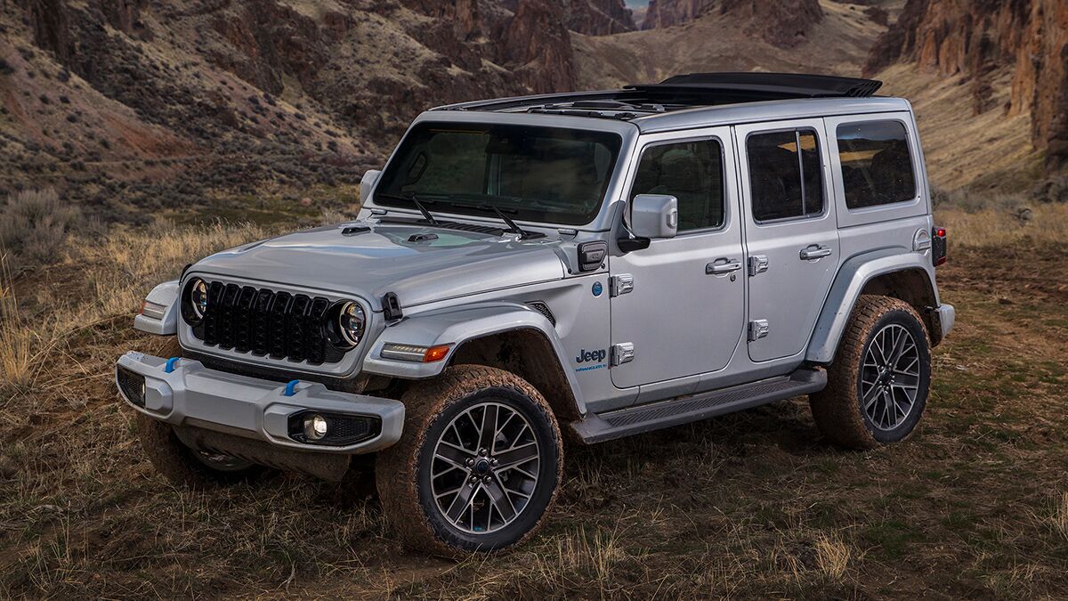 The 2024 Jeep Wrangler 4xe in gray seen from a front quarter angle