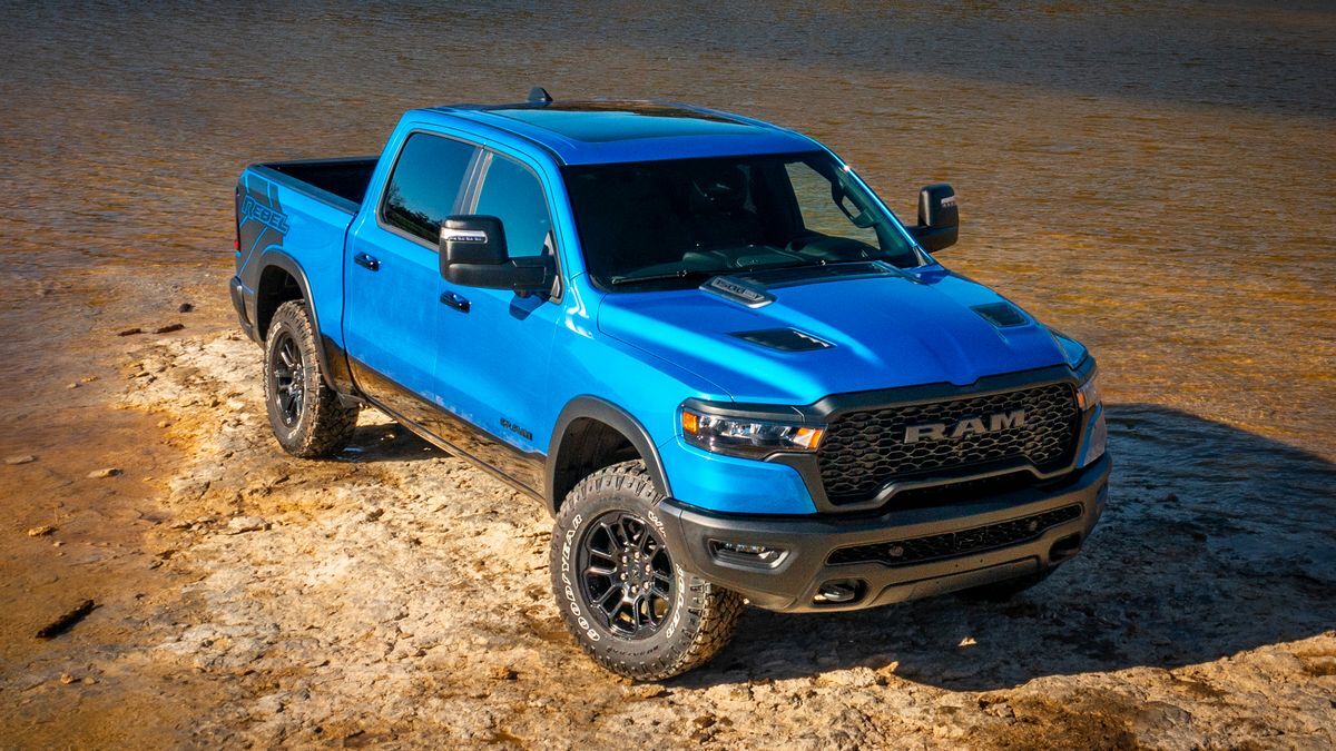 2025 Ram 1500 Rebel in blue parked on a lake bed.
