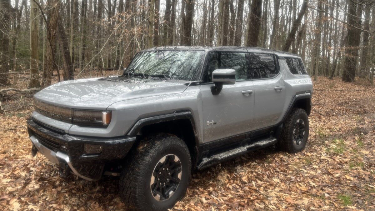 The 2025 GMC Hummer EV SUV in gray seen from a front quarter angle