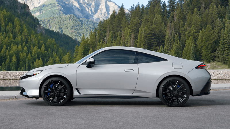 2026 Honda Prelude side view profile with a forest and mountains in the background.