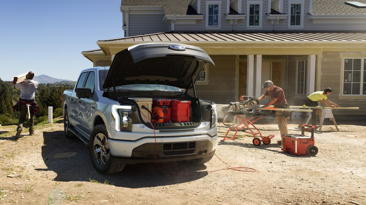 The 2022 Ford F-150 Lightning on a work site with its frunk open