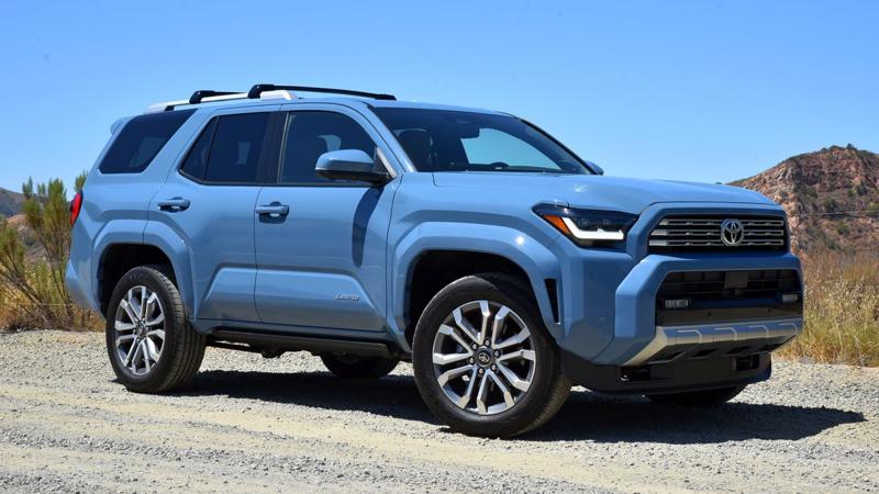 2025 Toyota 4Runner Limited in Heritage Blue with red hills in the background.